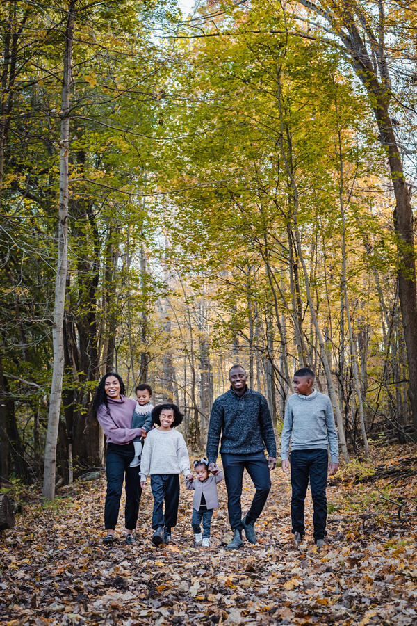 Families - mom and dad with 4 kids walking through forest