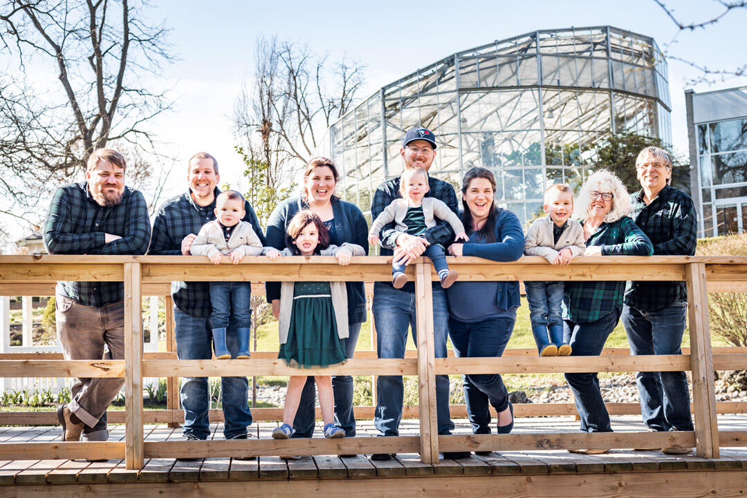 Family - Large family leaning against a bridge railing, smiling