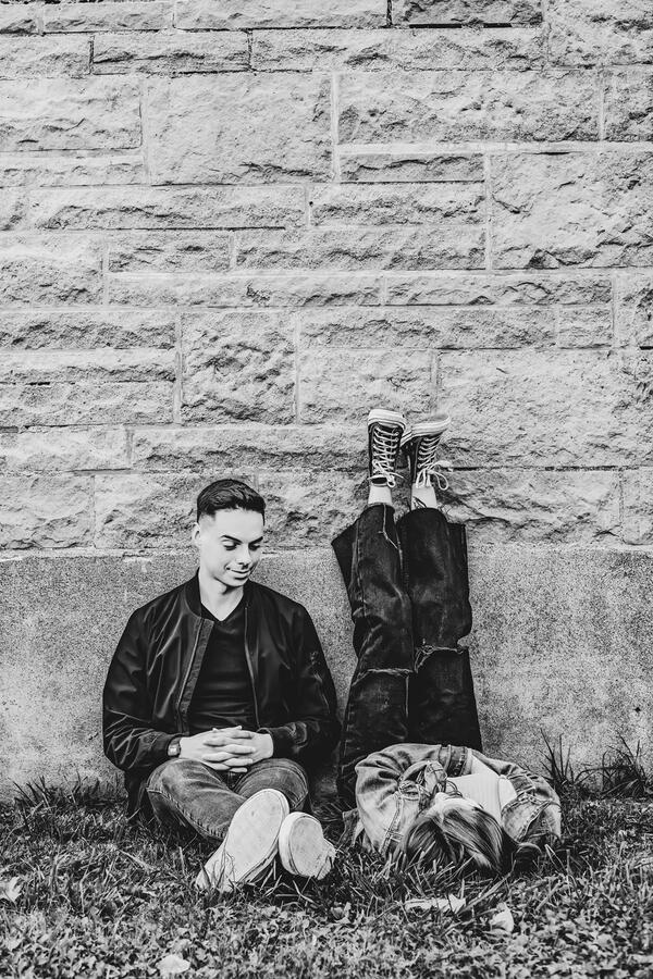 Family - Brother and sister leaning against a wall