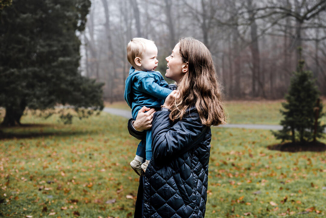 Families - mom holding son in arms, both looking at each other