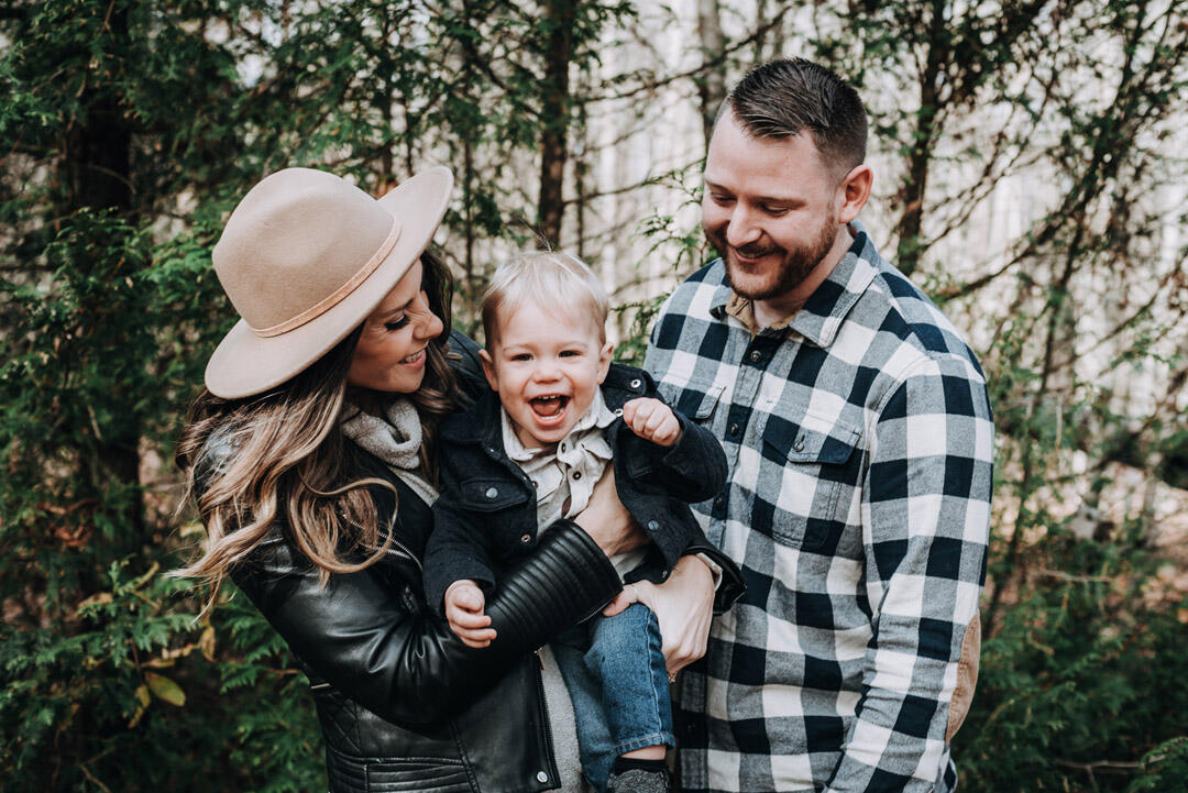 Untitled Families - mom and dad tickling toddler son while in their arms