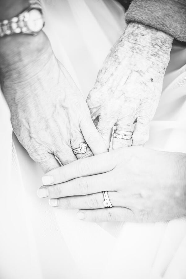 Three generations of hands & wedding rings: bride, brides' mother, brides grandmother