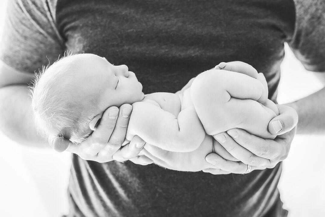 Untitled Baby - newborn being held in father's arms