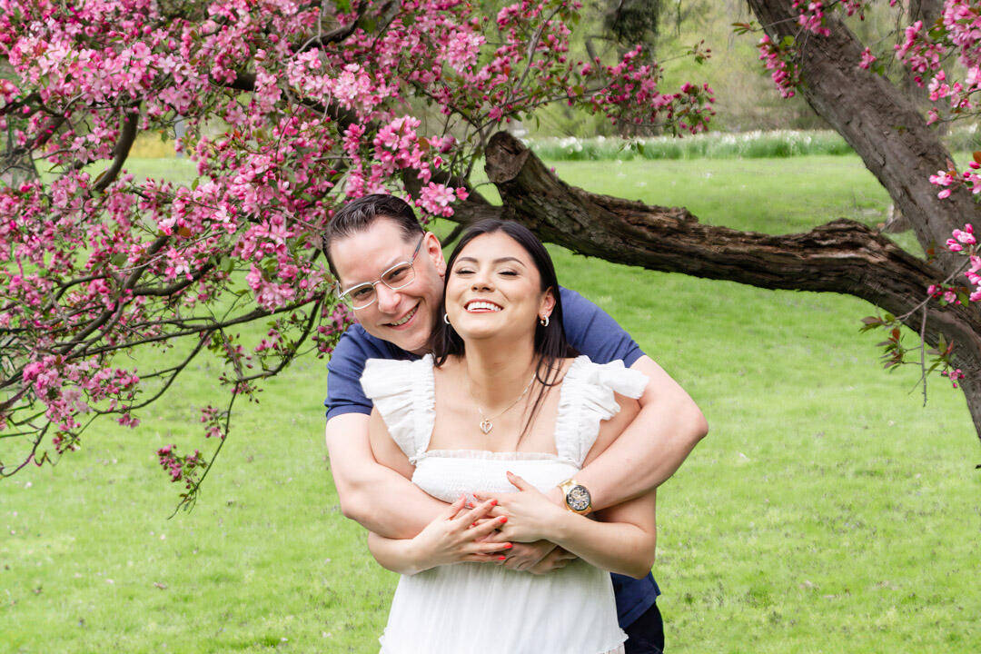 Couple - hugging and laughing under a blossom tree
